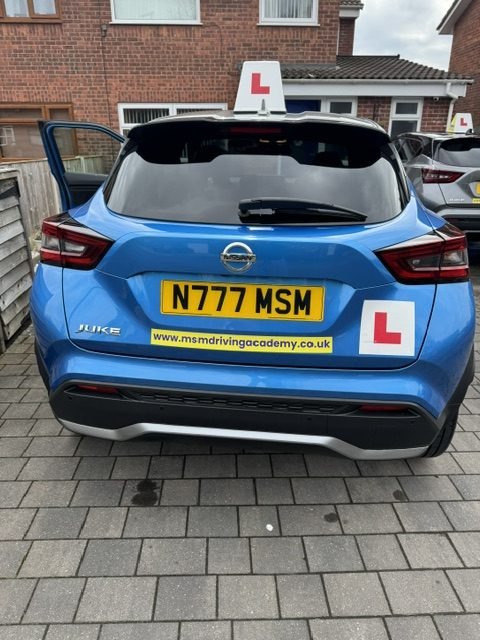 The rear of MSM Driving Academy's blue Nissan Juke tuition car