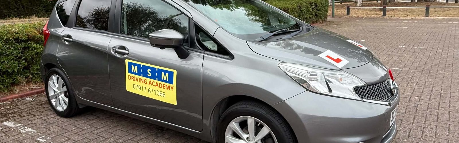Louise's grey Nissan Note with its MSM Driving Academy roof sign
